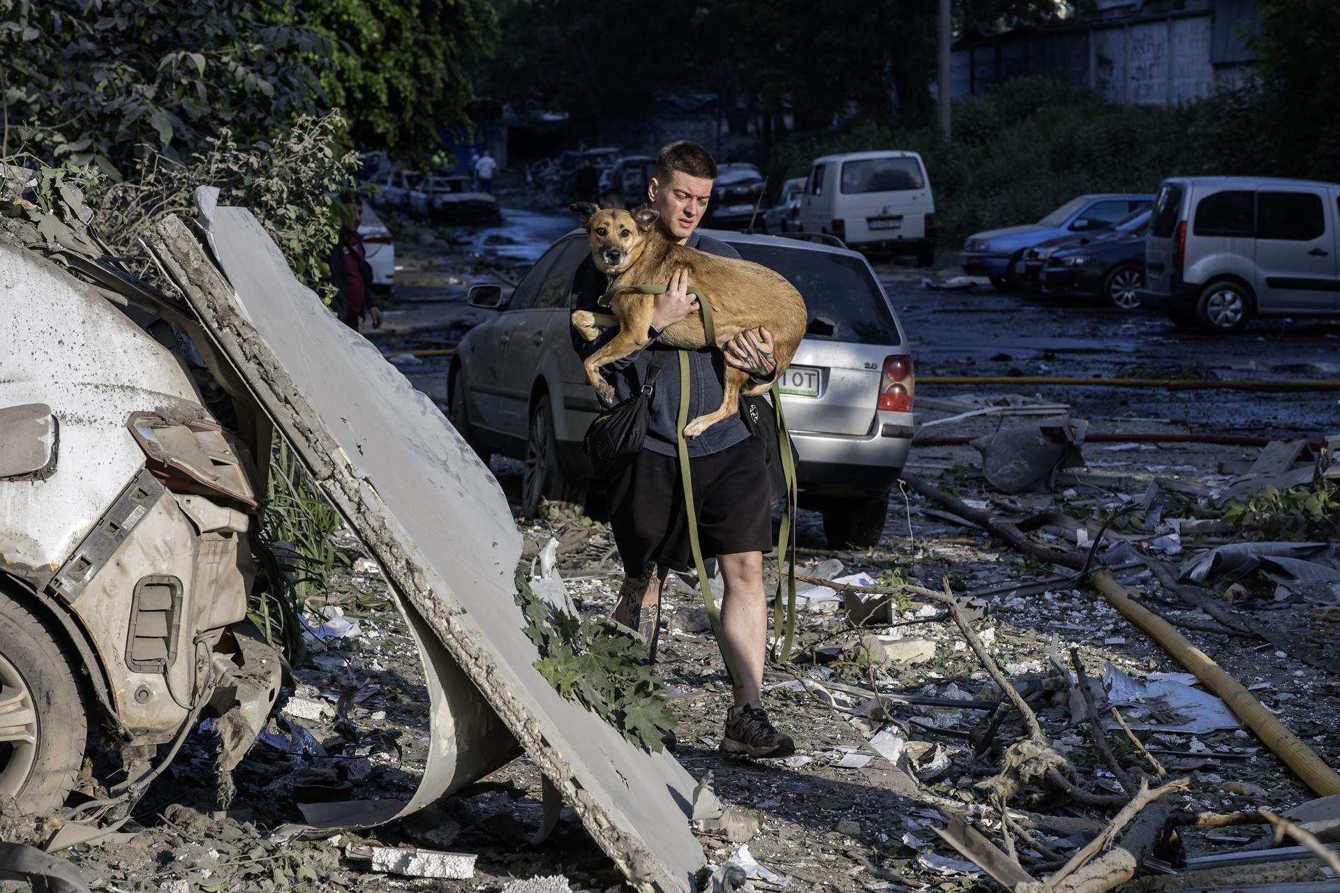 KYIV (Ukraine), 02/06/2026.- A man carries his dog at the site of a Russian strike on a residential area in Kyiv, Ukraine, 02 June 2026, amid the Russian invasion. At least four people were killed, and about 60 people were injured after a massive combined Russian attack overnight in Kyiv. At least 13 people died, and more than 100 were injured around Ukraine, according to the Ukrainian emergency services. Russia used more than 650 drones and more than 70 missiles of different types during the massive combined attack on Ukraine, as the air forces reported. (Rusia, Ucrania, Kiev) EFE/EPA/MAXYM MARUSENKO

